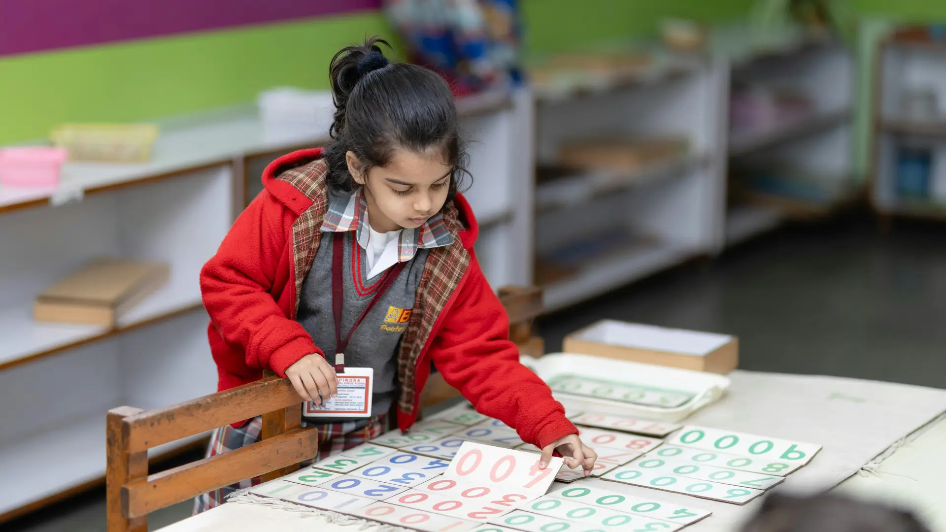Young child using sensorial materials in a Montessori education environment.